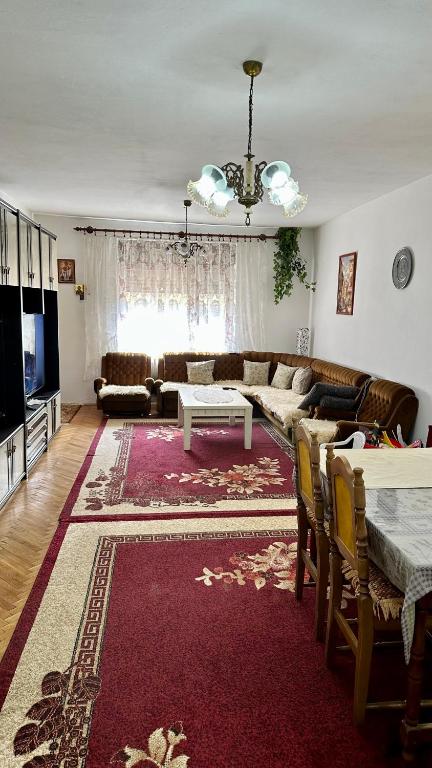 a living room with a couch and a table at Adria spa Rafailovici in Bečići