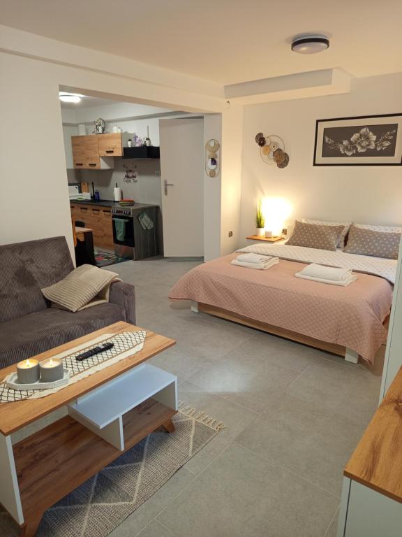 a bedroom with a large bed and a couch at Mieszkanie do wynajęcia w Centrum in Olecko