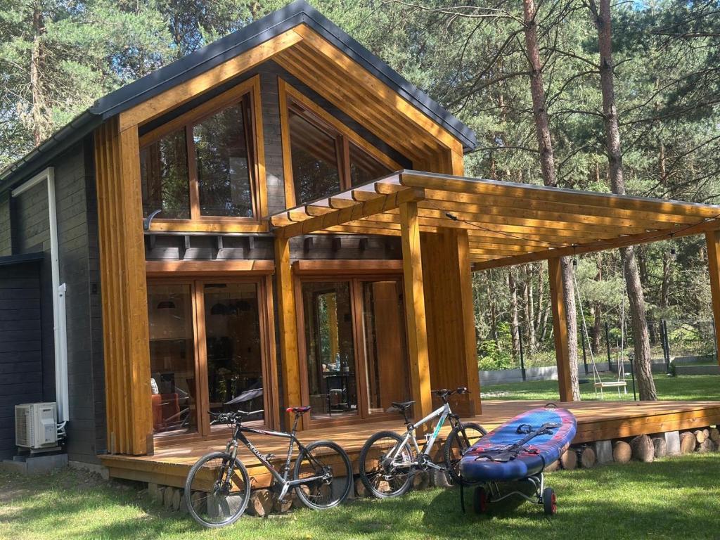 a house with two bikes parked outside of it at Nowoczesna STODOŁA Łozówka in Chańcza