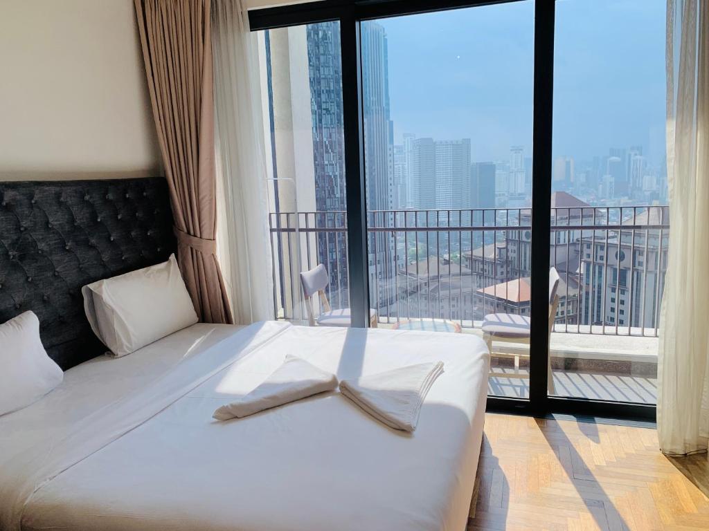a bedroom with a bed with a bow tie on it at KLCC The Mews Luxury suites Malaysia in Kuala Lumpur