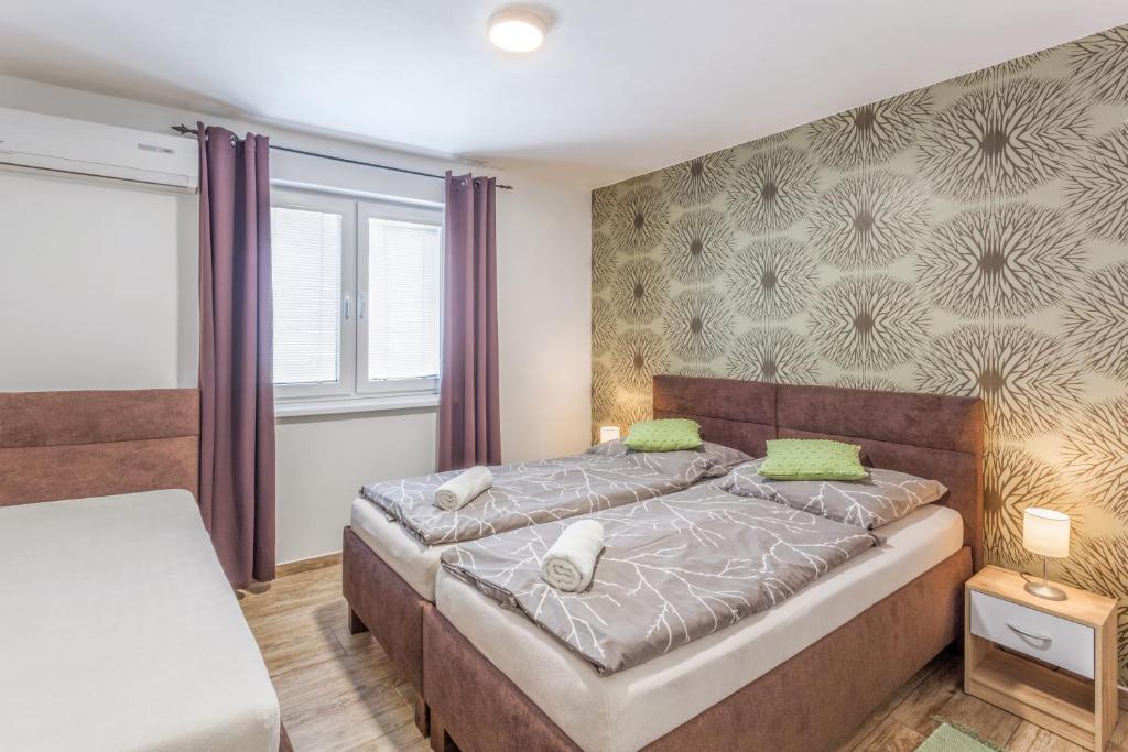 Postel nebo postele na pokoji v ubytování Apartmány pod Pálavou
