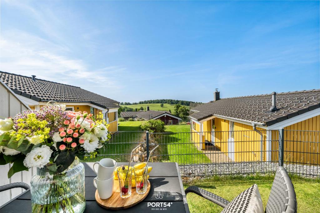 a table with a vase of flowers on top of it at Ferienhaus Platzhirsch - Sankt Andreasberg im Harz in Sankt Andreasberg