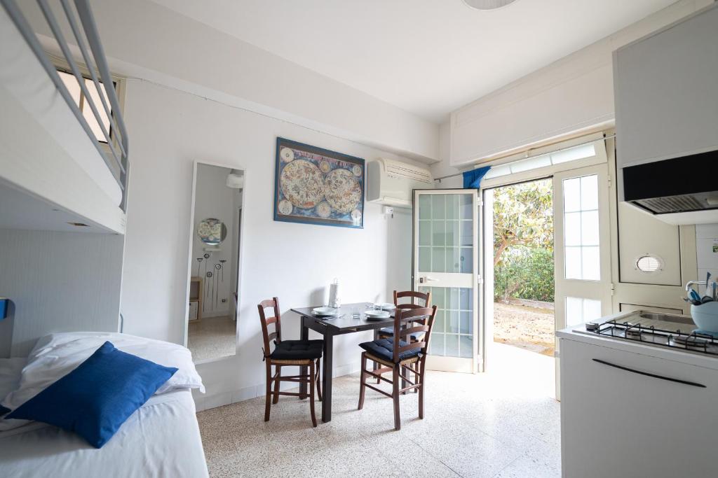 a kitchen and dining room with a table and chairs at Vivilo Collection - Santa Laura Loft with Garden in Sperlonga