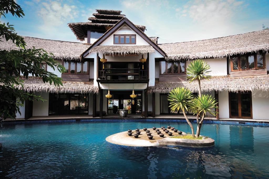 a pool in front of a house with a building at Villa Samadhi by Samadhi - Adults Only in Kuala Lumpur