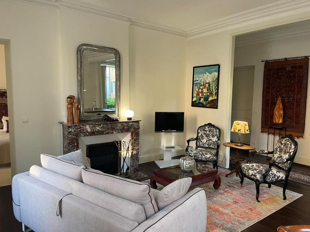 a living room with a couch and a fireplace at Appartement "La Marquise" centre de Grignan in Grignan