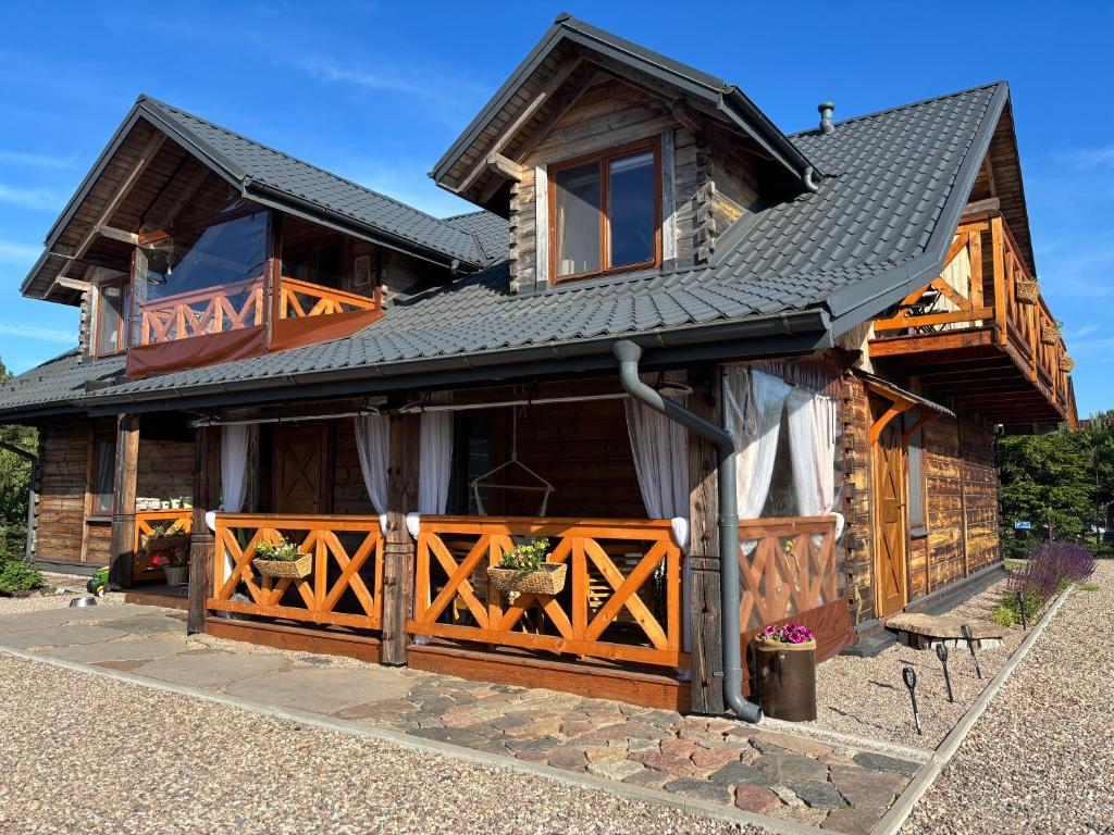 a wooden house with a gate in front of it at Józwówka Swornegacie in Swornegacie