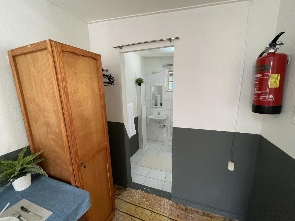 a bathroom with a red fire hydrant and a fire hydrant at Simple Studio at Studenthouse Casa Caia in Willemstad