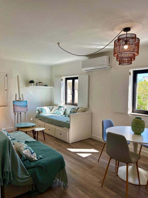 a living room with a bed and a table at Delta Marina Vilamoura in Quarteira