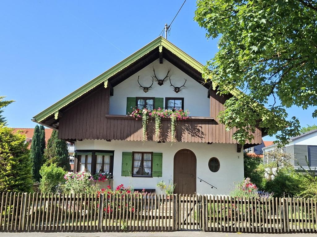 a small house with a fence in front of it at Haus Mayer in Weilheim in Oberbayern