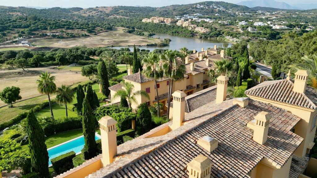 an aerial view of a house with a swimming pool and trees at Chalet Adosado for Rent in Sotogrande in San Roque