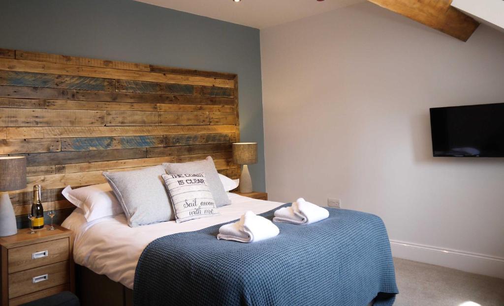 A bed or beds in a room at The Belfry Whitby 