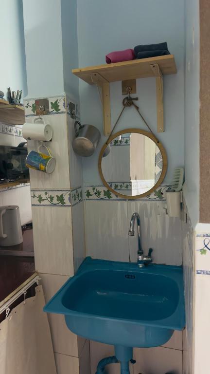 a bathroom with a blue sink and a mirror at Lam NguyenVn Minihouse in Can Tho