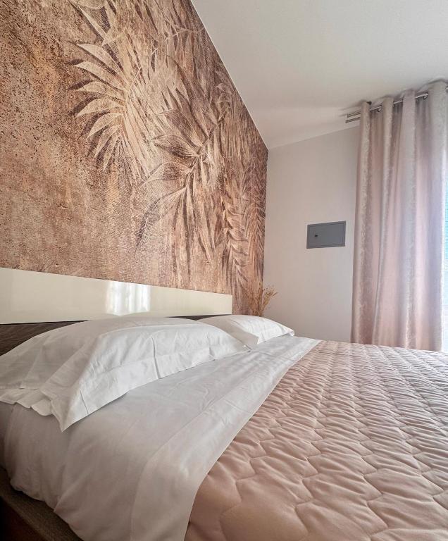 Postel nebo postele na pokoji v ubytování Garda Lake Holiday Apartments quadrilocale
