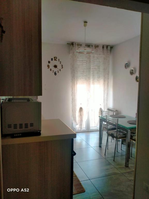 a kitchen and dining room with a table and a dining room at Perla Marina in Montesilvano