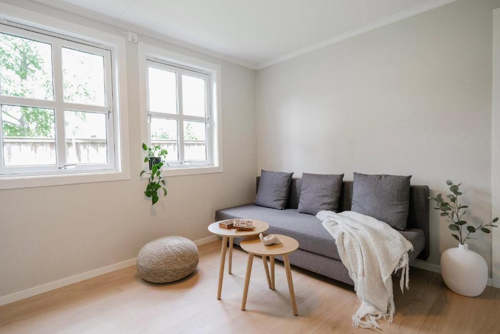 a living room with a couch and a table at Cozy apartment - Walking distance to Kristiansand city center in Kristiansand