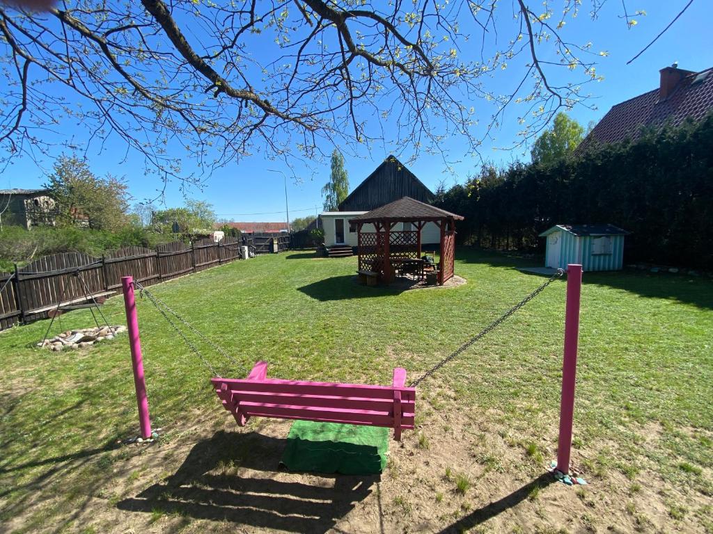 a playground with a pink bench and a gazebo at Grzybowo in Ryn