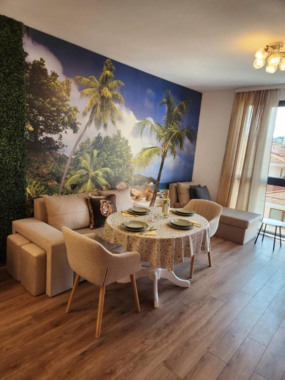 a living room with a table and a couch at Lili Azur beach appaartment in Varna City
