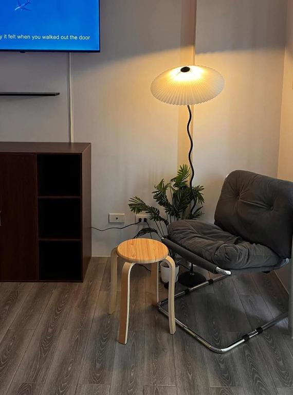 a living room with a couch and a table and a lamp at Lay Cozy Mactan- Condo Staycation and Layovers in Pusok