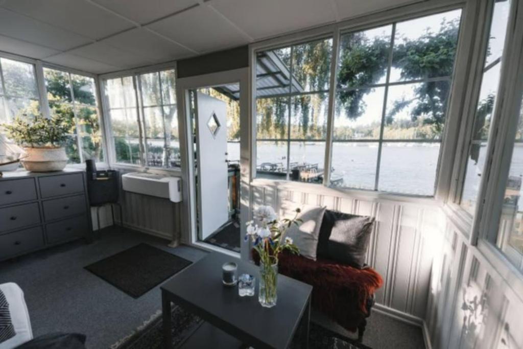 a living room with a view of the water at Serene lakeside cabin next to the sea just 10 minutes from Stockholm city in Solna