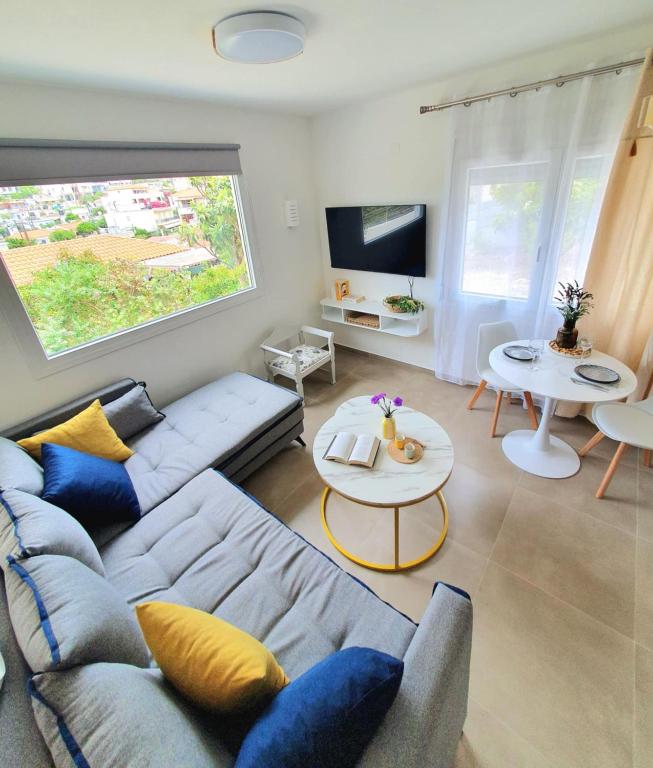 a living room with a couch and a table at Julia's Home in Patitiri