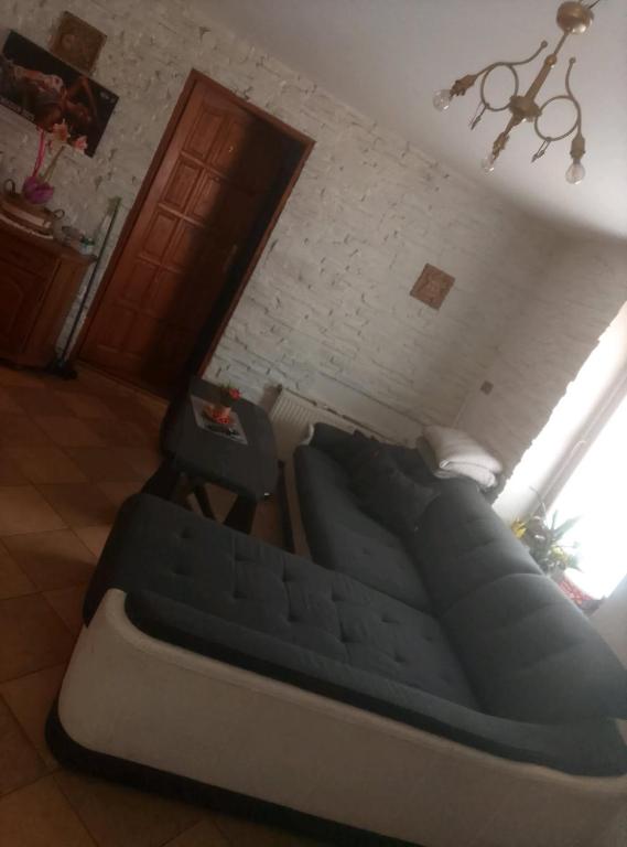 a bed in a room with a chair and a window at Apartament in Psary Małe
