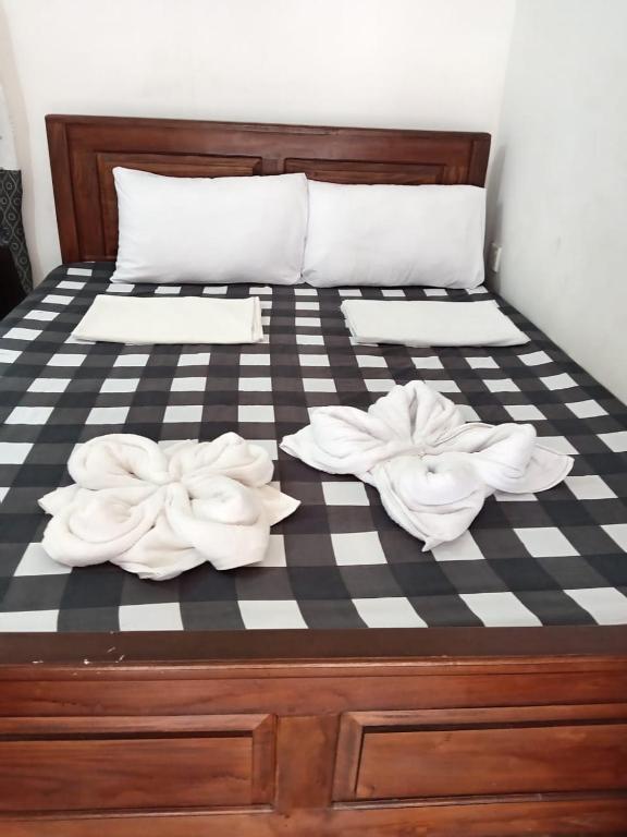 a bed with two white towels on it at TrincoBeCoolGuest & Hostel in Trincomalee
