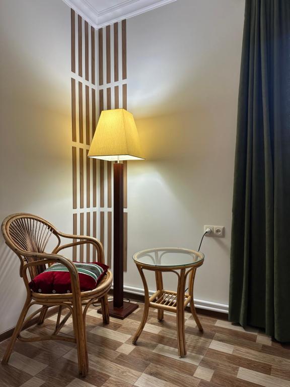 a room with a table and two chairs and a lamp at TAGANI Guest Rooms in Martuni