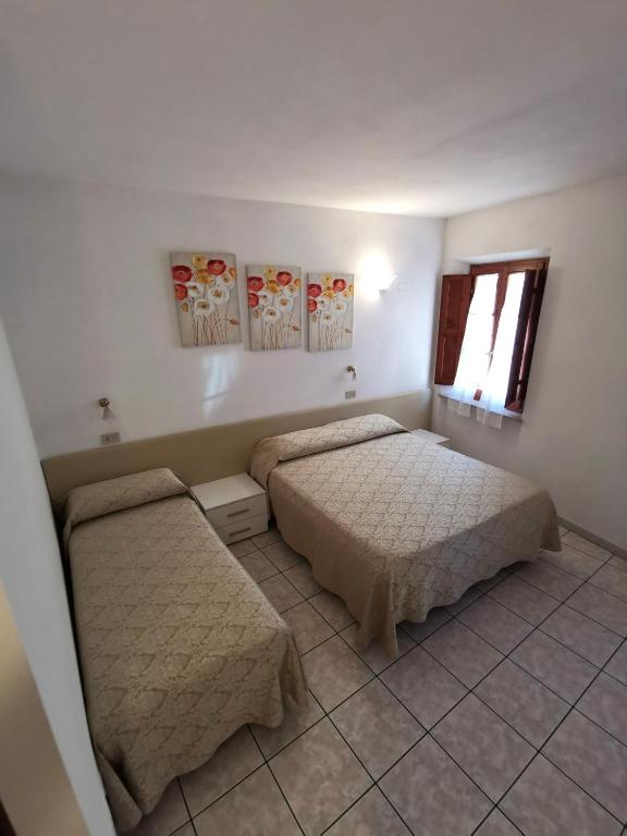 Postel nebo postele na pokoji v ubytování Camere la torre