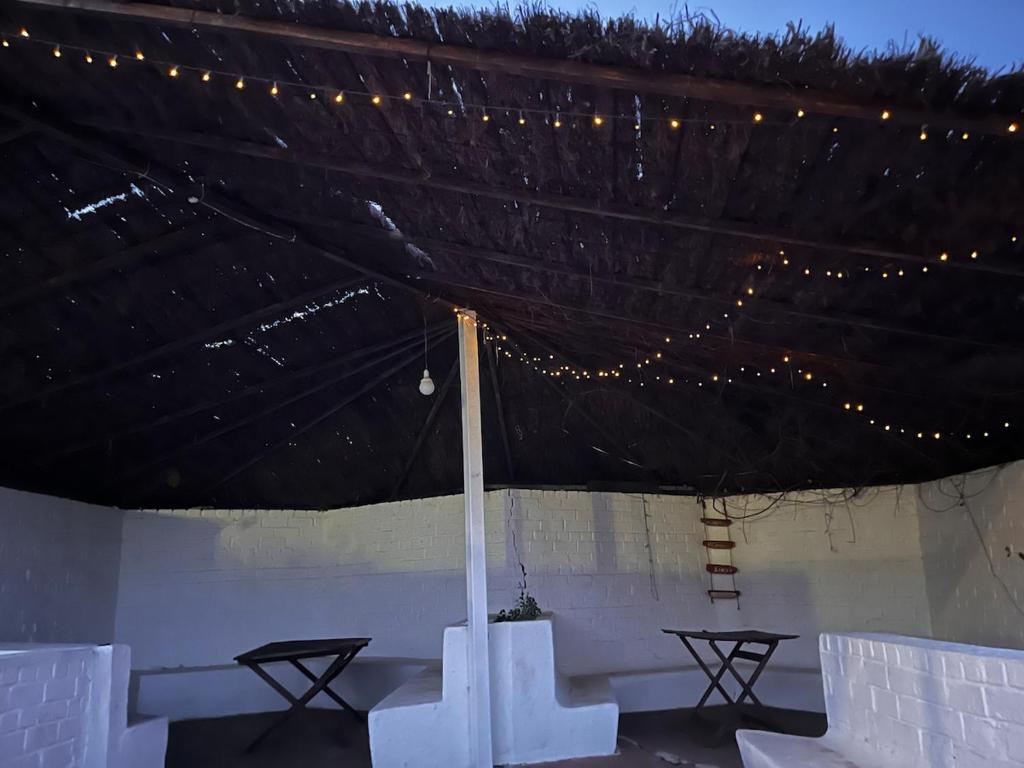 a tent with two tables and lights on it at Blue house Nature and calm in Tarifa