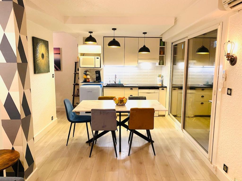 une cuisine et une salle à manger avec une table et des chaises dans l'établissement Superbe 2 pièces Palavas, à Palavas-les-Flots