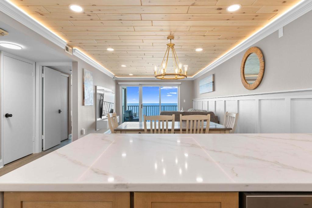 a kitchen and dining room with a view of the ocean at Spectacular Oceanfront Penthouse - Unit 1203 in Ocean City