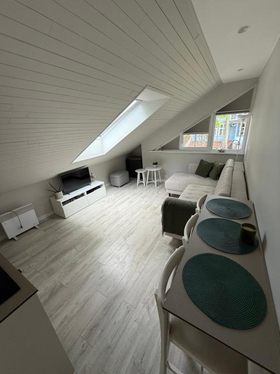 a living room with a couch and a table at Marių kampelis in Juodkrantė