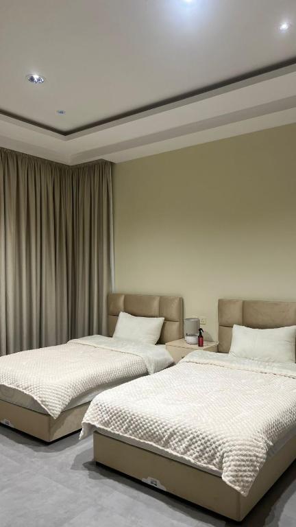 two beds sitting next to each other in a bedroom at استديو جديد in Hail