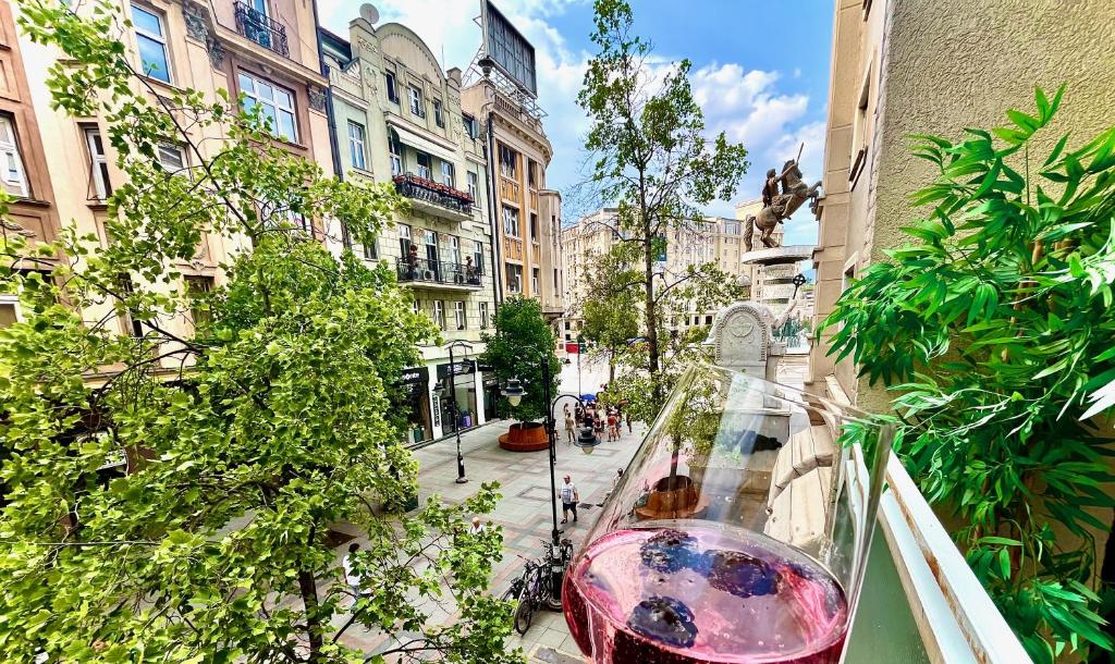 a glass vase sitting on a balcony in a city at Macedonia Square Suite 22 - Pedestrian Street in Skopje