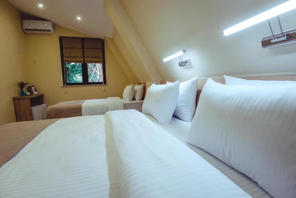 Postel nebo postele na pokoji v ubytování Hotel Brick House