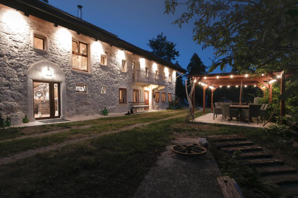 a building with a table and chairs in front of it at TheGreenShelter in Čepovan