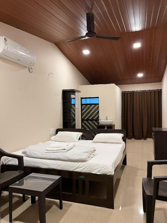a hospital room with two beds and a fan at WKND Casa in Panchgani