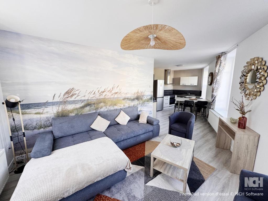 a living room with a blue couch and a table at Au Cœur de Boulogne in Boulogne-sur-Mer