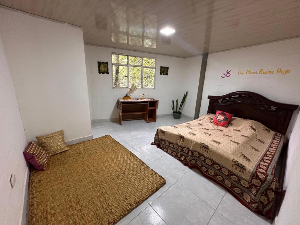 Postel nebo postele na pokoji v ubytování La Casa De Los Sueños Colombia Centro de Bienestar y Hostel Temático Ancestral