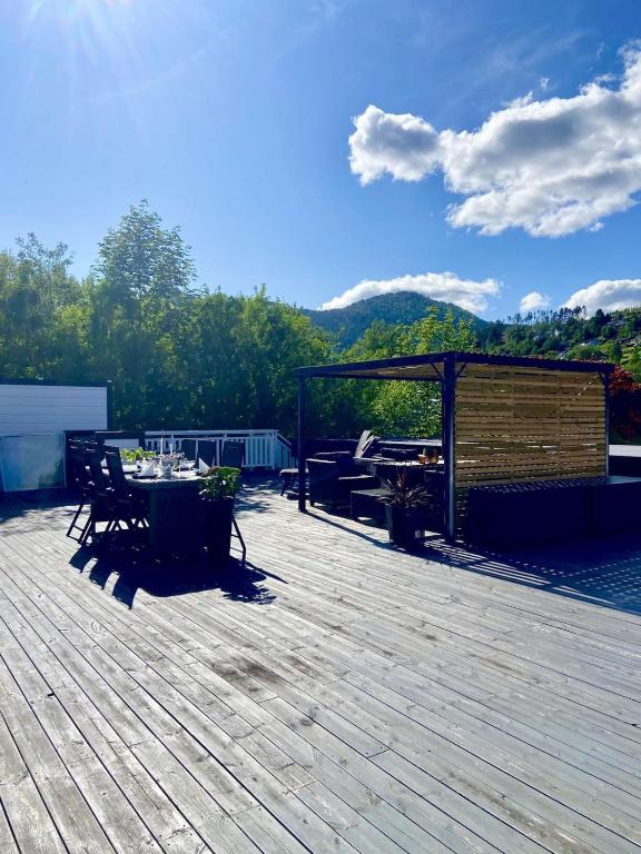 a patio with a table and chairs on a deck at Apartment in Stryn in Stryn