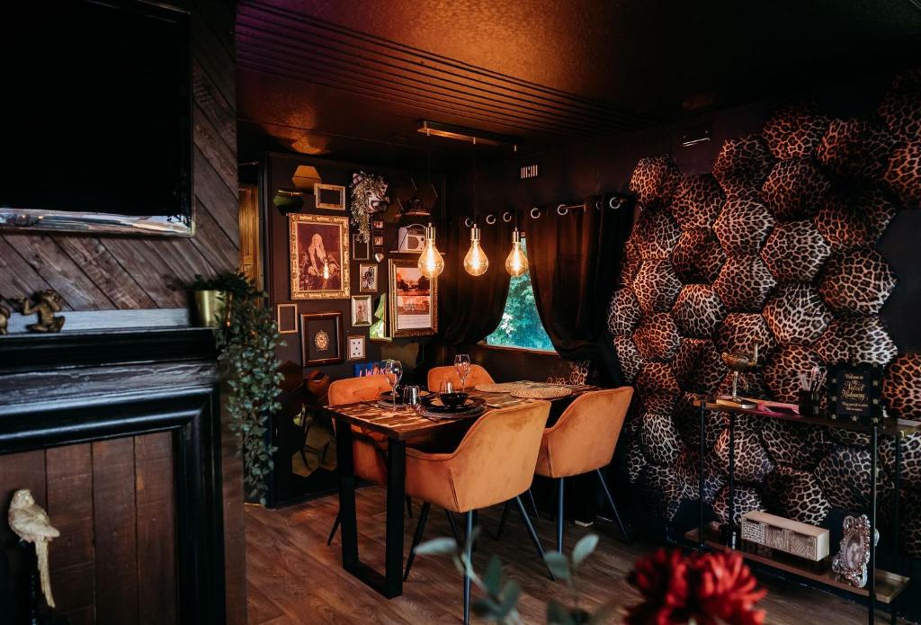 a dining room with a table and chairs at The Velvet Hideaway in Burnham on Sea