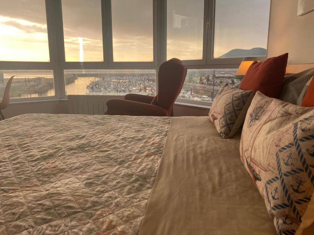 a bedroom with a bed with a view of a city at Laredo Ocean Port in Laredo