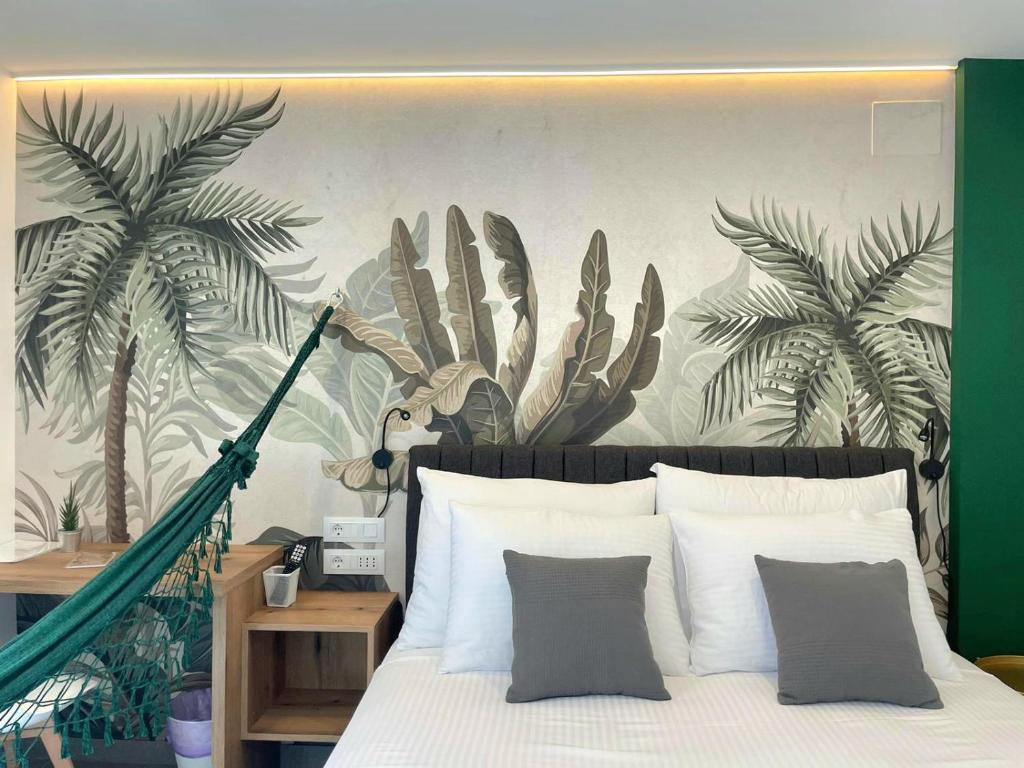 a bedroom with a bed with a mural of palm trees at Botique Studio - Casa El Sueño II in Vodnjan