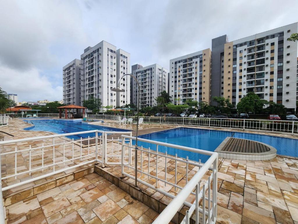 a swimming pool in a city with tall buildings at Apartamento condomínio clube in São Luís