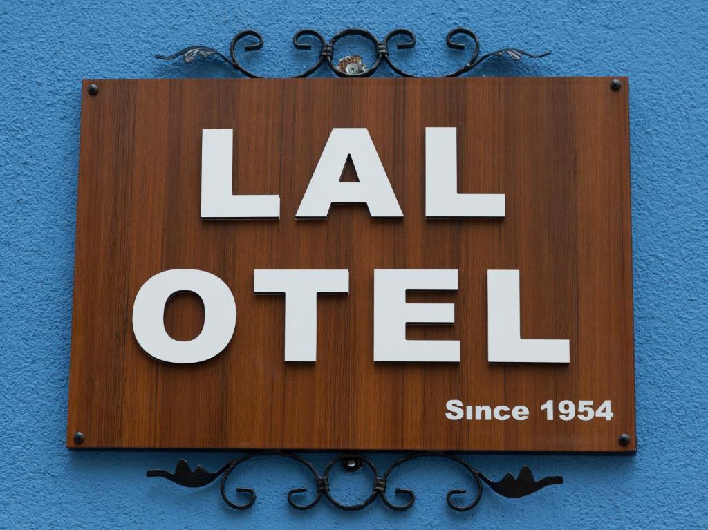 a sign on a blue wall that reads la otel at Lal Hotel Bursa in Bursa
