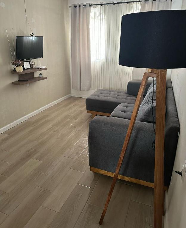 a living room with a couch and a lamp at Casa Michel in Tepic