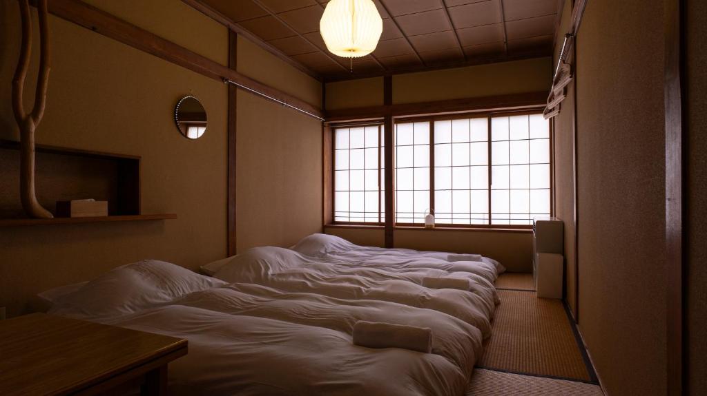 Postel nebo postele na pokoji v ubytování Hakuba Hospitality Inn YUKINOSO
