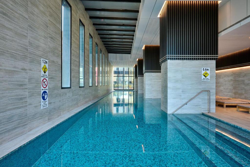 a swimming pool in a building at Stay Fit & Relax - 2BR with Gym & Spa in Melbourne