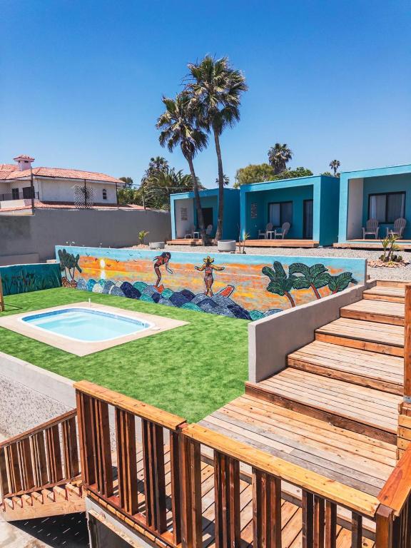 a mural on the side of a building with stairs and a pool at Ocean's Heaven in Ensenada