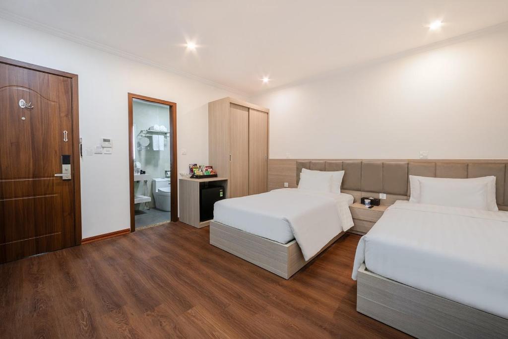 Postel nebo postele na pokoji v ubytování A25 Hotel - Hoàng Đạo Thúy 2